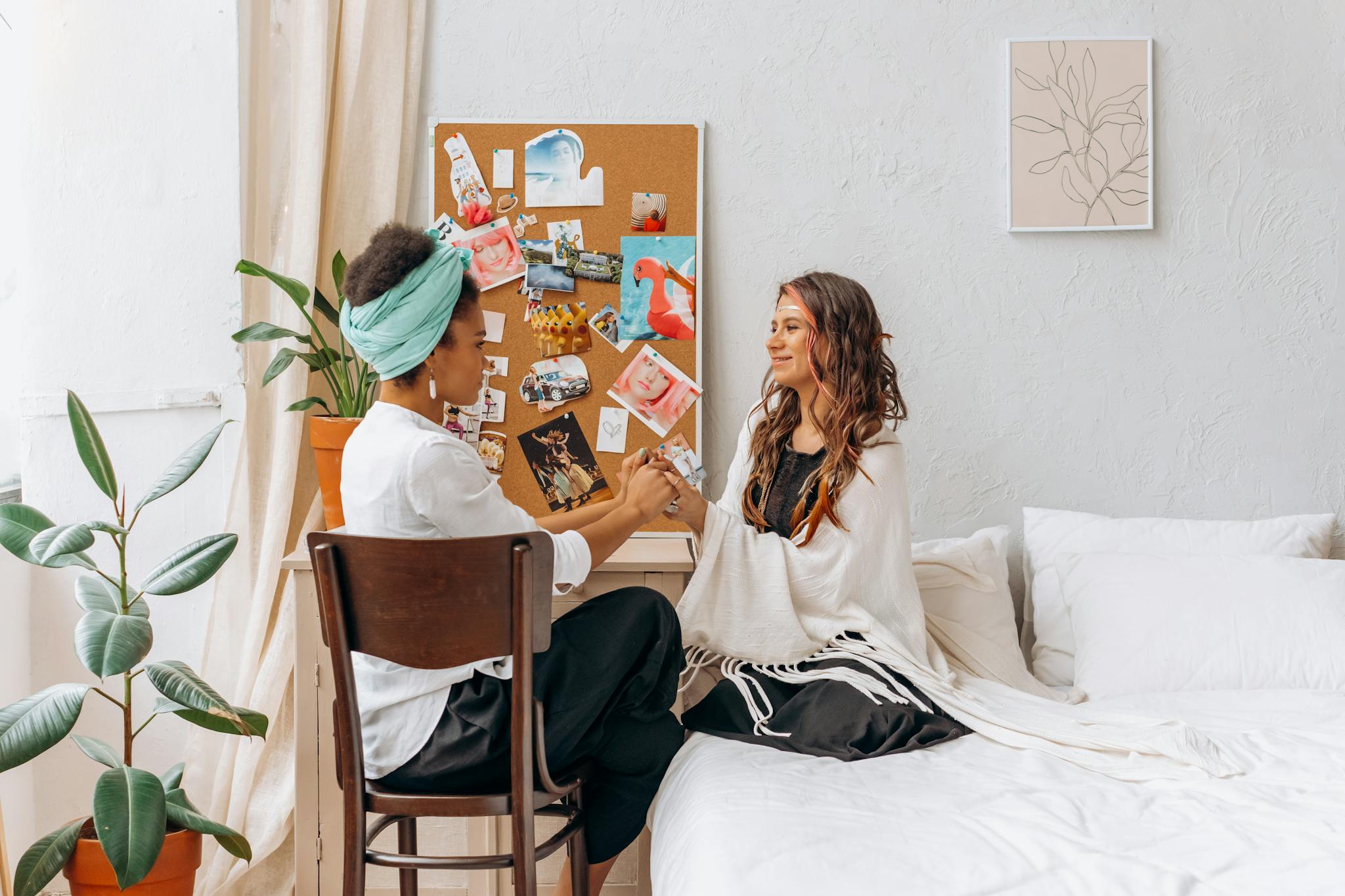 Two women sharing a mindful and spiritual moment in a cozy, indoor setting, promoting wellness and connection.